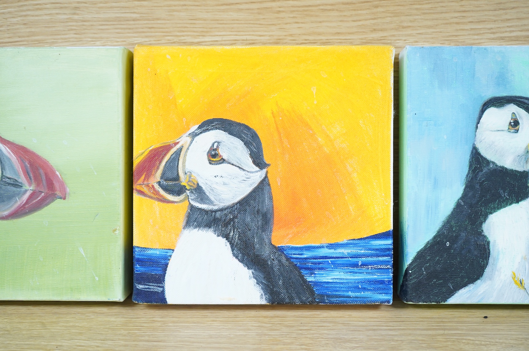 Siobhan O'Malley (Irish, contemporary), Studies of puffins, a set of three oils on canvas, each signed and dated 2010 verso, 20 x 20cm unframed
